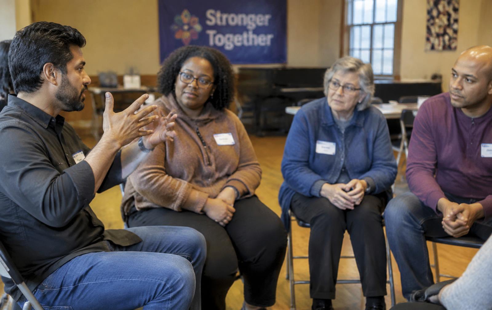 Community members seated in a circle during a leadership discussion